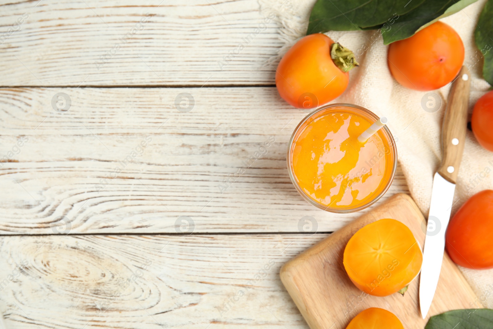 Photo of Tasty persimmon smoothie and fresh fruits on white wooden table, flat lay. Space for text