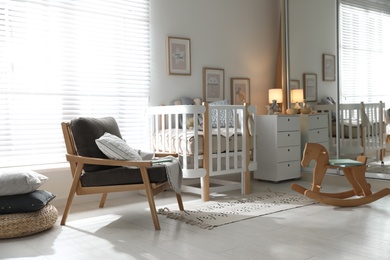 Baby room interior with crib, armchair and rocking horse. Idea for design
