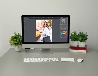 Image of Designer's workplace. Computer with photo editor application on table