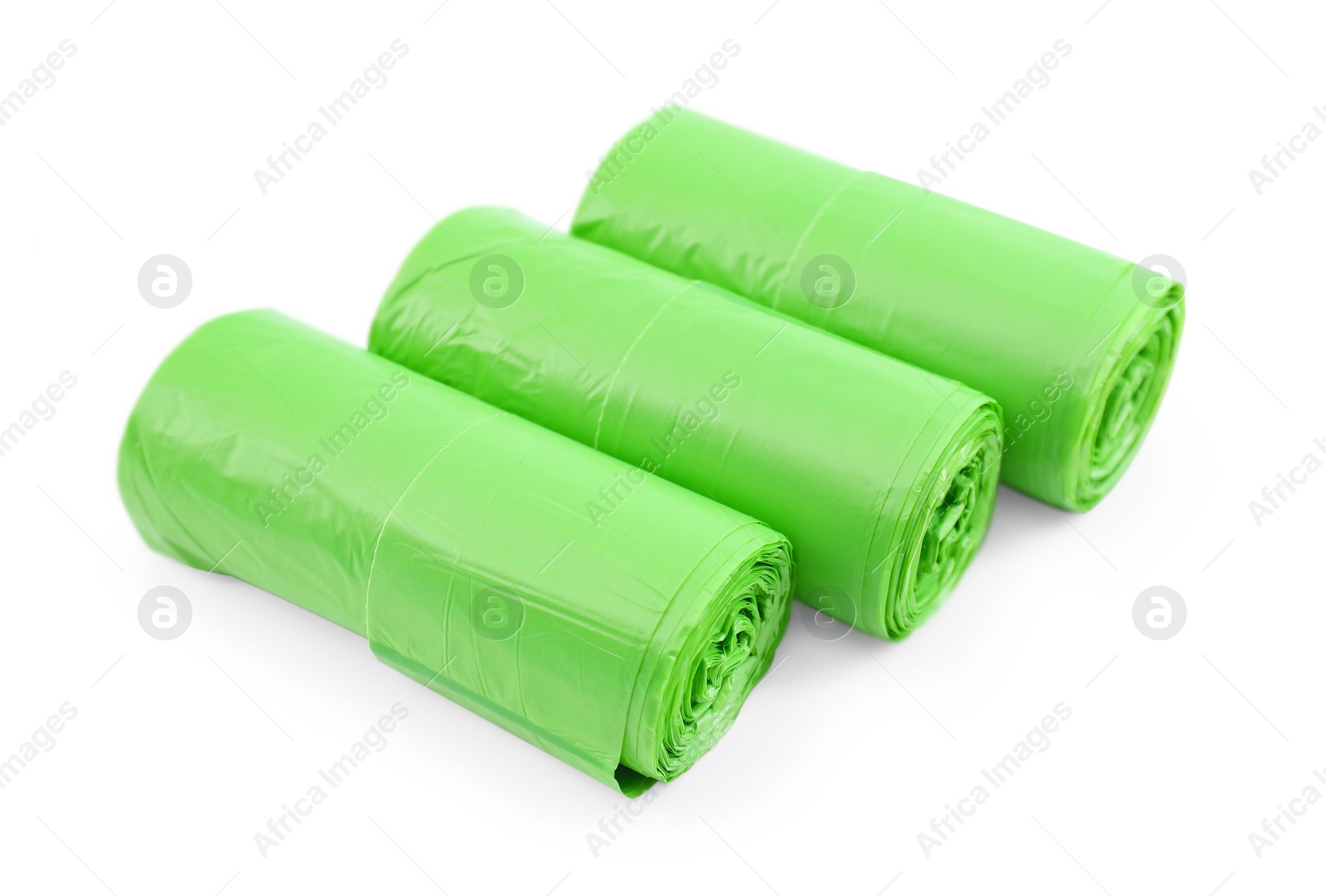 Photo of Rolls of light green garbage bags isolated on white