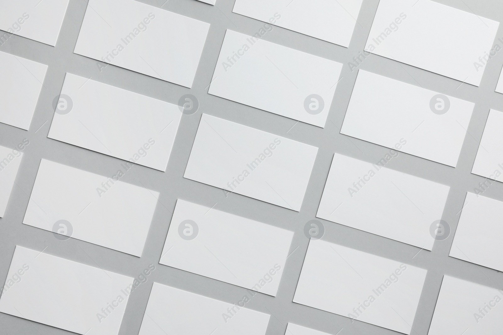 Photo of Blank business cards on light gray background, flat lay. Mockup for design