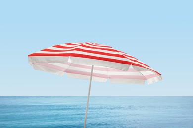 Open big beach umbrella near sea on sunny day 