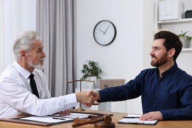 Photo of Lawyer shaking hands with client in office