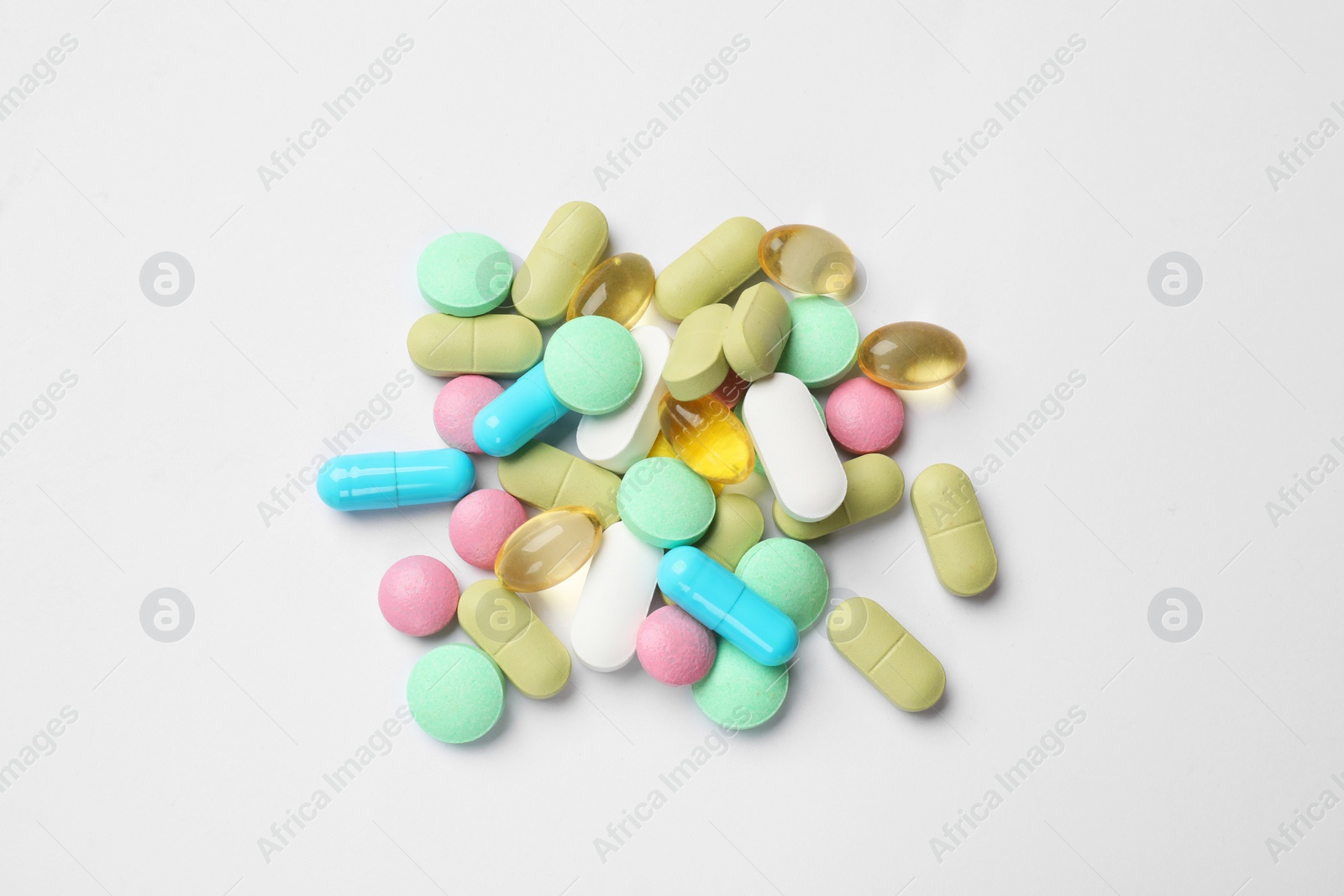 Photo of Different vitamin pills on white background, top view