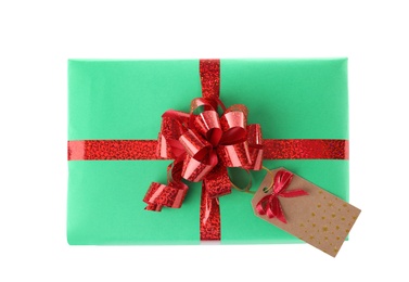 Photo of Christmas gift box decorated with ribbon bow on white background, top view