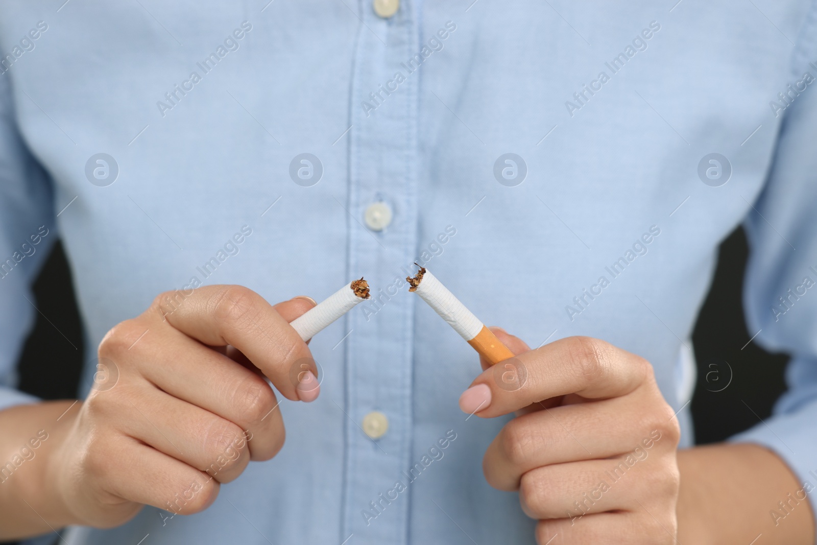 Photo of Stop smoking concept. Woman breaking cigarette, closeup