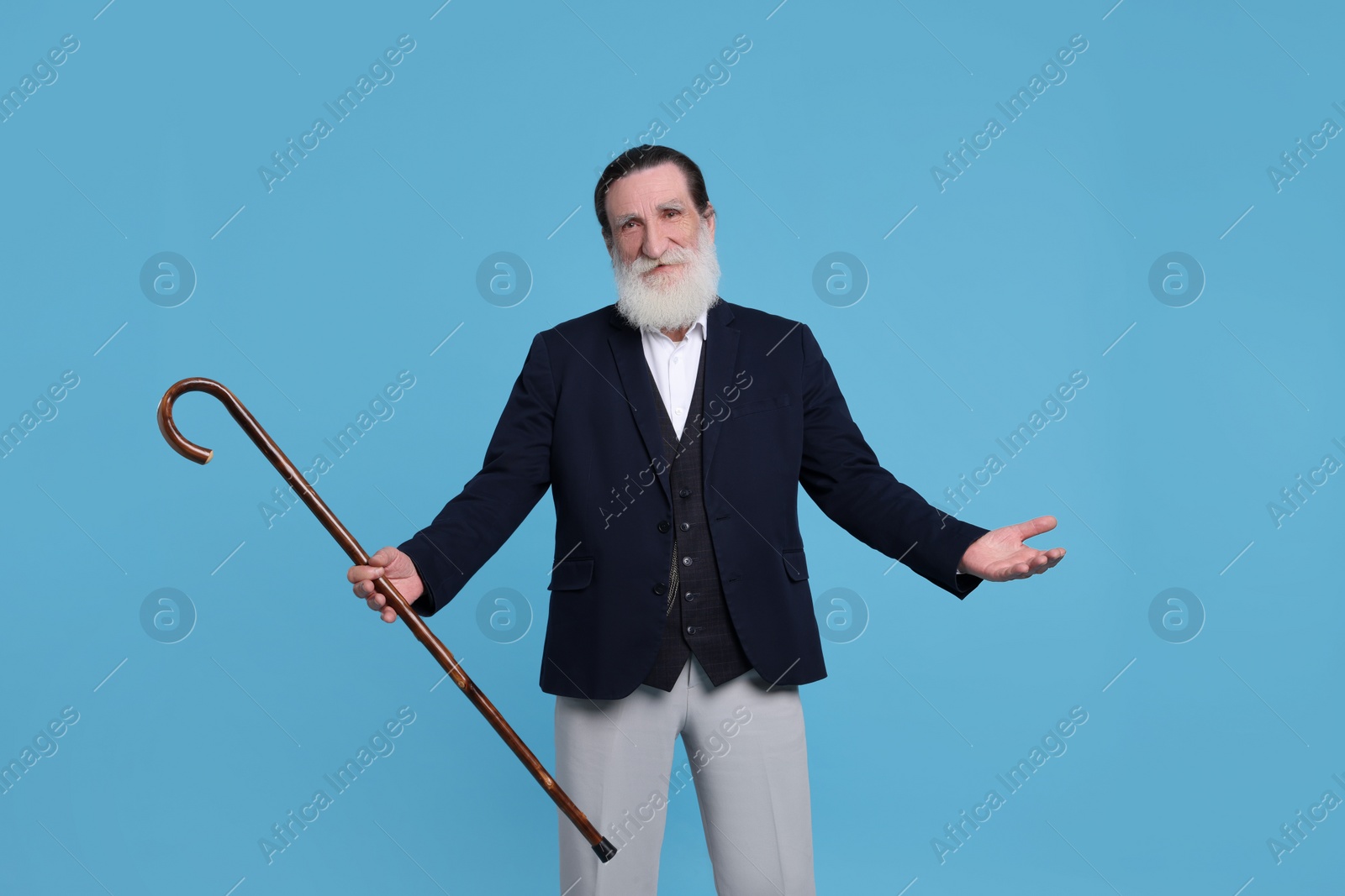 Photo of Senior man with walking cane on light blue background