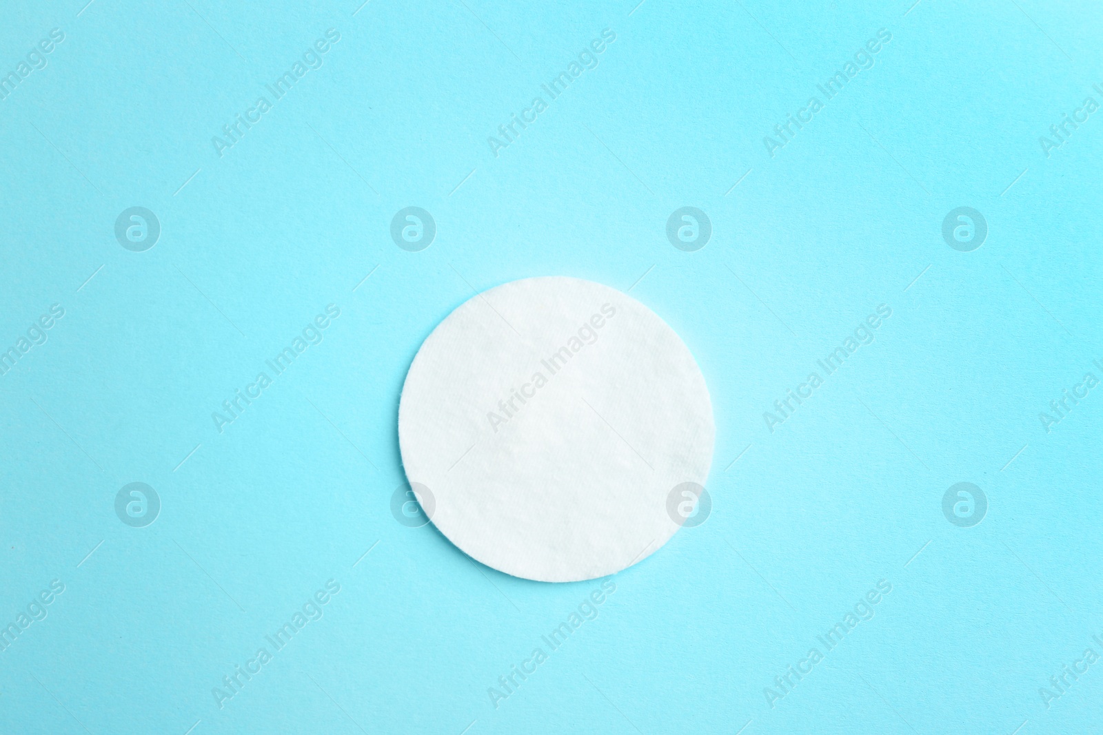 Photo of Cotton pad on color background, top view