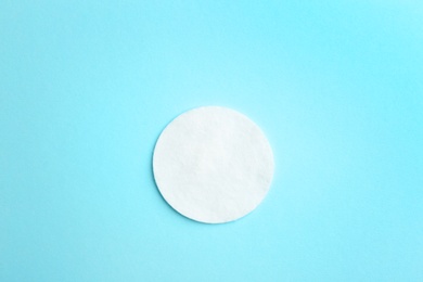 Photo of Cotton pad on color background, top view