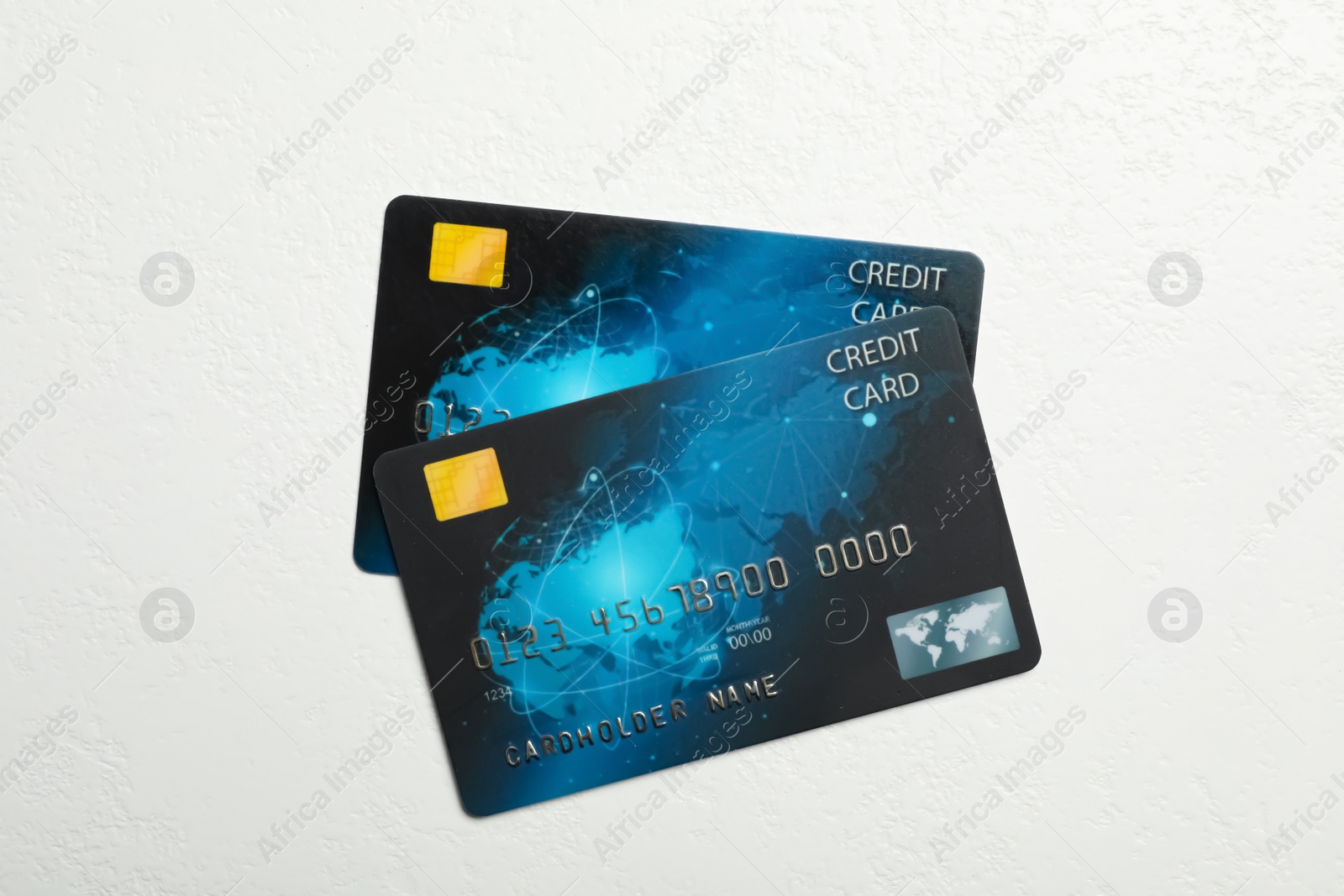 Photo of Credit cards on white table, flat lay