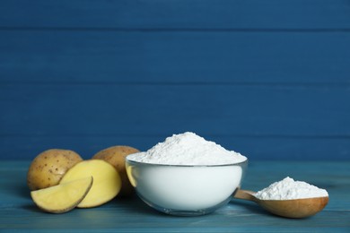 Photo of Starch and fresh raw potatoes on light blue wooden table. Space for text