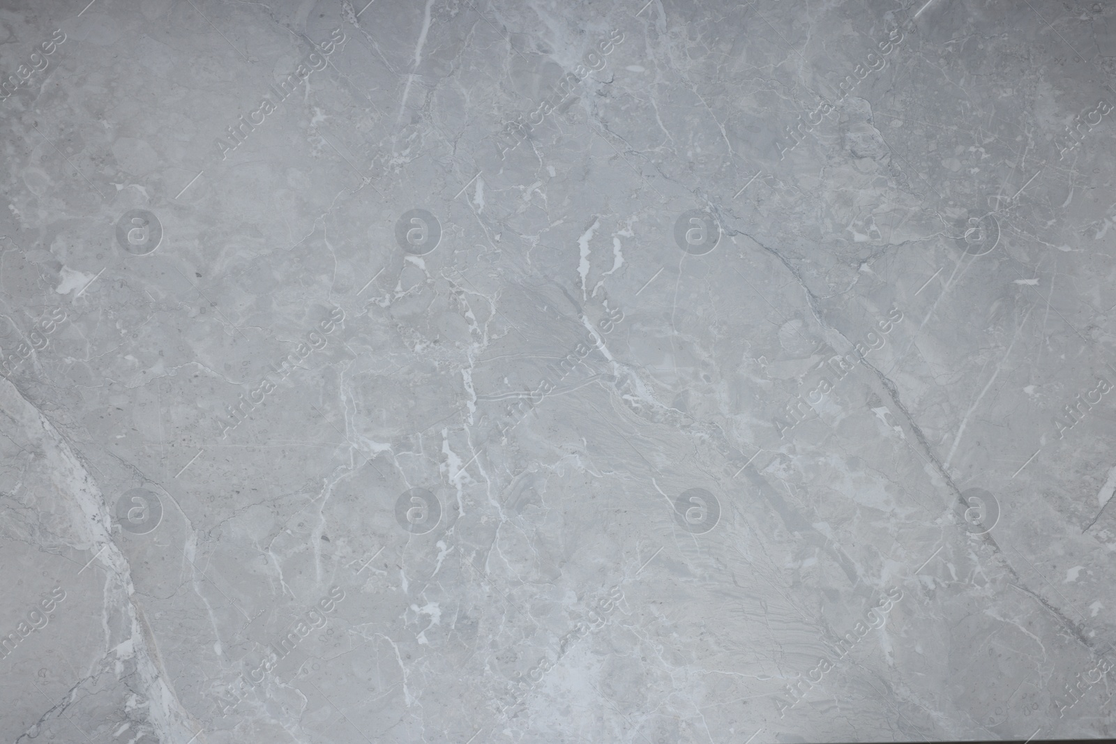 Photo of Texture of light grey marble surface as background, closeup