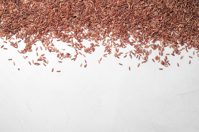 Photo of Brown rice on white background, top view