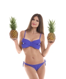 Photo of Sexy young woman in bikini with pineapples on white background
