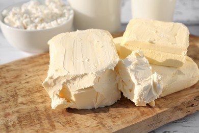 Photo of Tasty homemade butter and dairy products on white wooden table, closeup