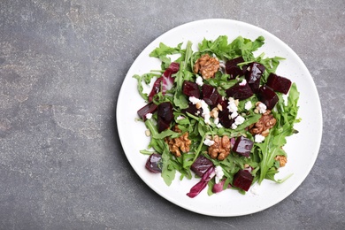 Photo of Delicious beet salad served on grey table, top view