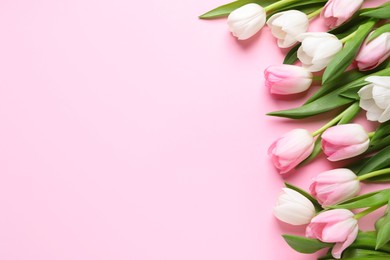 Photo of Beautiful spring tulips on pink background, flat lay. Space for text