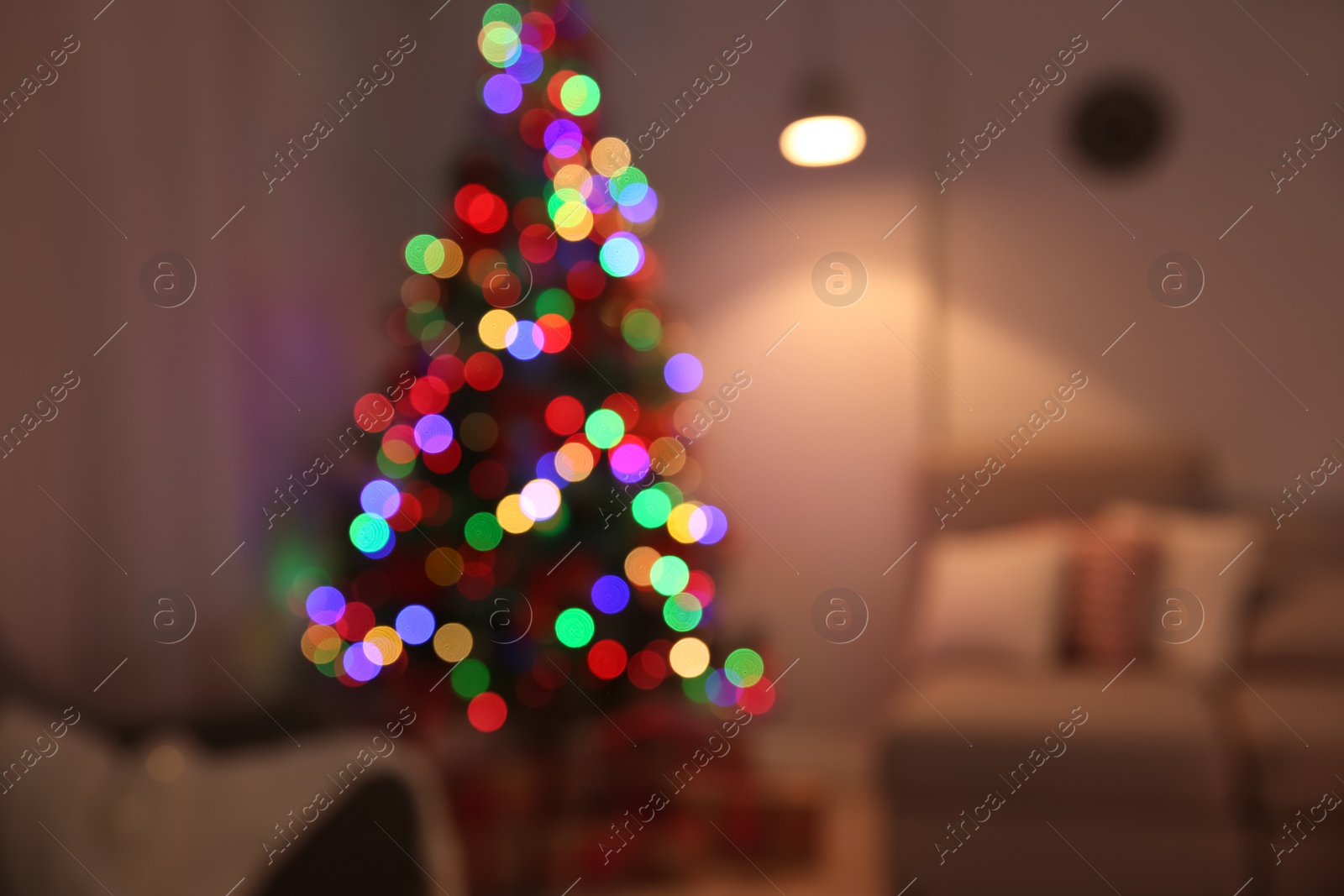 Photo of Blurred view of stylish room interior with decorated Christmas tree