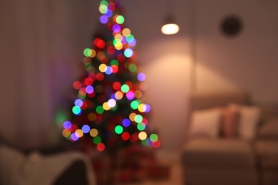 Photo of Blurred view of stylish room interior with decorated Christmas tree