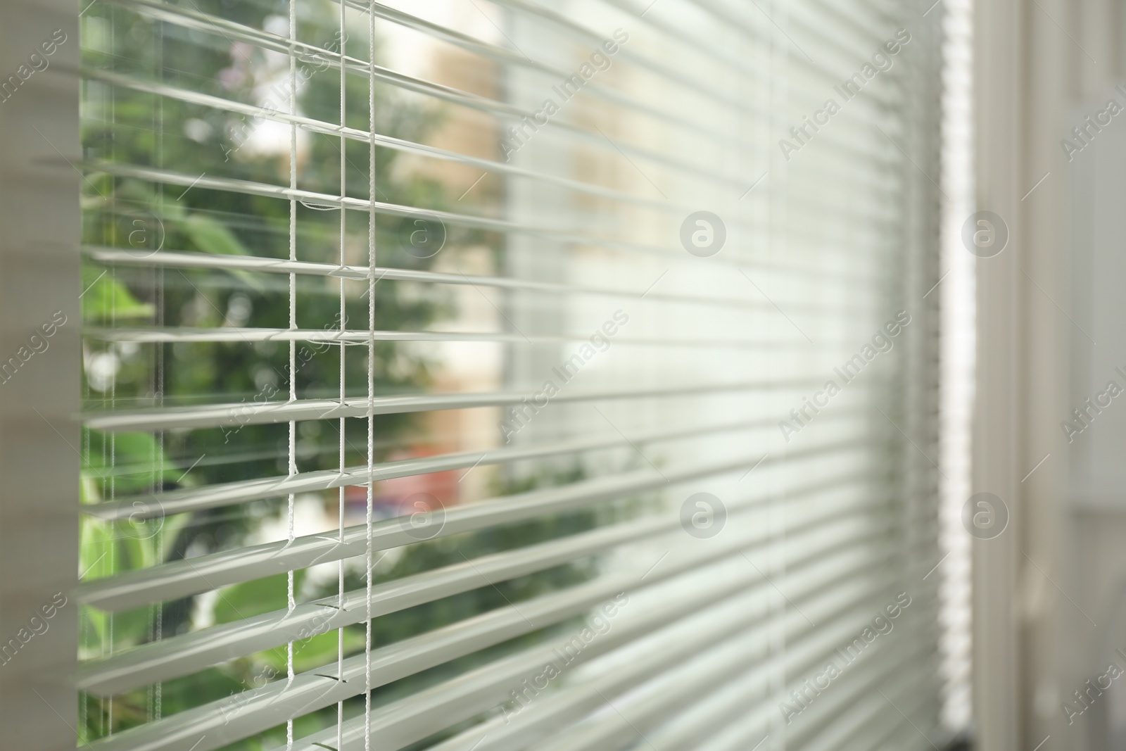 Photo of Closeup view of window with clean blinds indoors