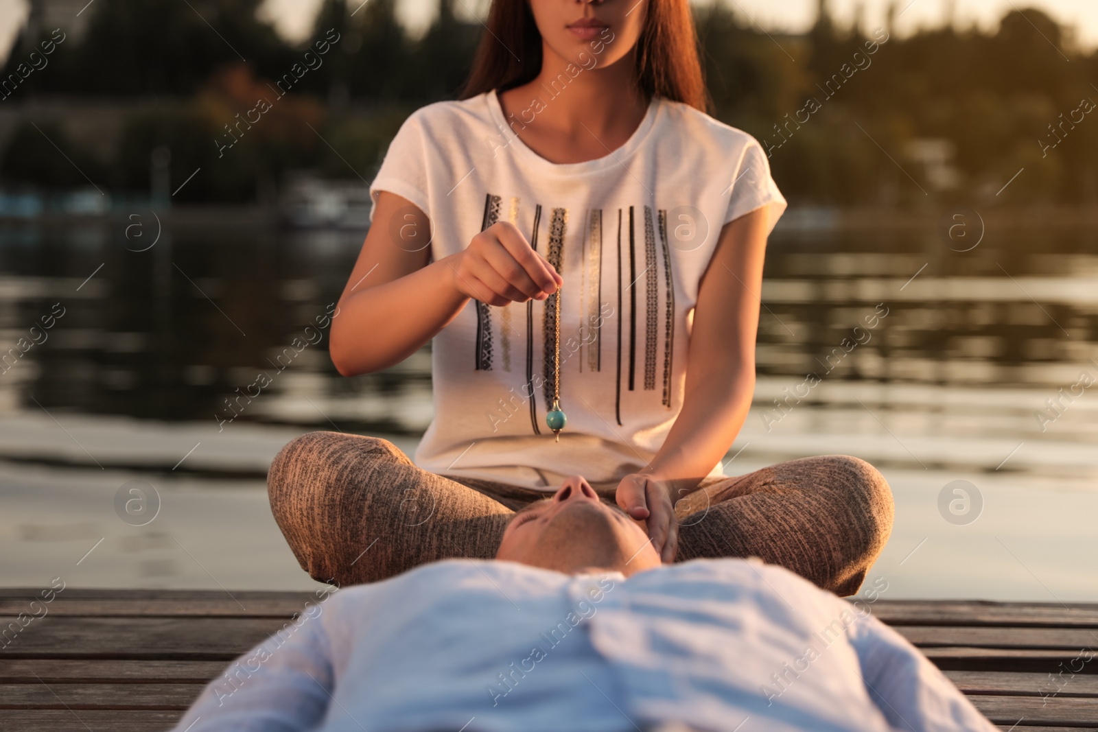 Photo of Man at crystal healing session near river outdoors