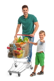 Father and son with full shopping cart on white background