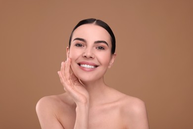 Photo of Beautiful woman with healthy skin on light brown background. Body Care