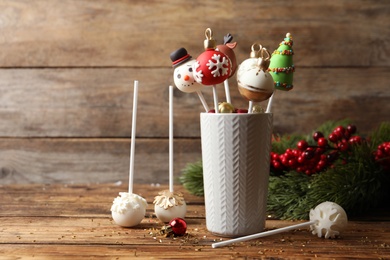 Delicious Christmas themed cake pops on wooden table. Space for text