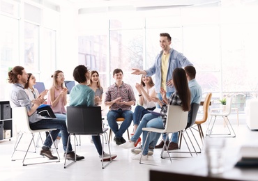 Male business trainer giving lecture in office