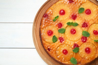 Photo of Delicious pineapple pie with cherry and mint on white wooden table, top view. Space for text