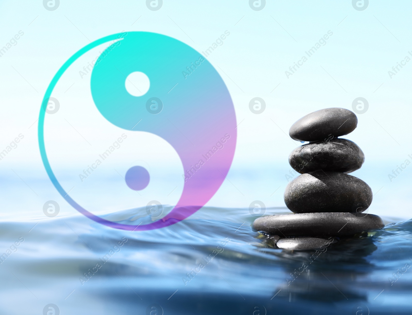 Image of Stack of stones in water and Ying Yang symbol. Feng Shui philosophy 