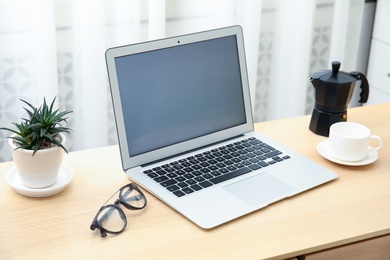 Photo of Cozy blogger workplace with laptop at home