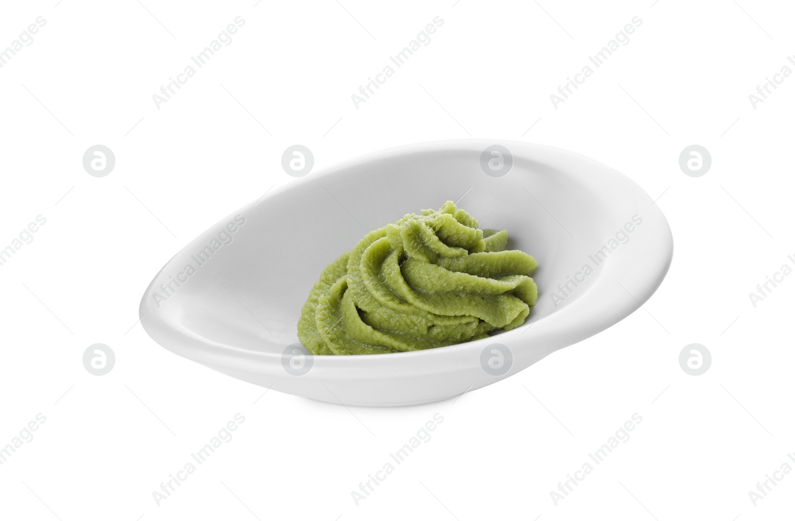 Photo of Bowl with swirl of wasabi paste isolated on white