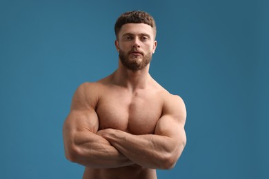 Photo of Handsome muscular man on light blue background. Sexy body
