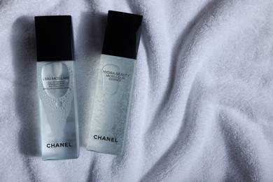 Photo of Leiden, Netherlands - July 14, 2022: Chanel cosmetic products on white towel, flat lay. Space for text