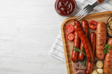 Photo of Flat lay composition with delicious grilled sausages on white wooden table, space for text. Barbecue food