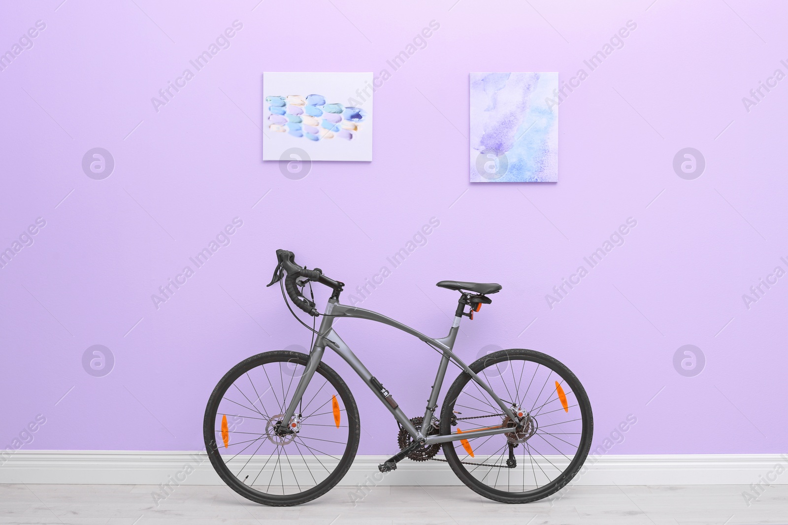 Photo of Room interior with modern bicycle against color wall