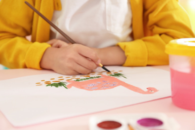 Photo of Little child painting at table, closeup view