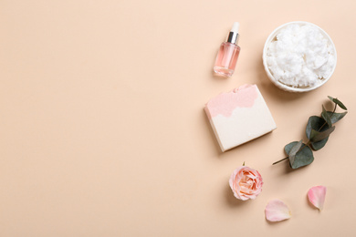 Flat lay composition with natural handmade soap and ingredients on beige background. Space for text