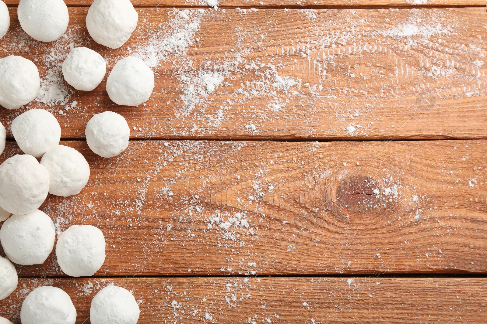 Photo of Snowballs on wooden background, flat lay. Space for text