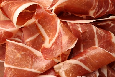 Photo of Slices of tasty cured ham as background, top view
