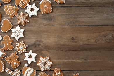 Photo of Many different delicious Christmas cookies on wooden table, flat lay. Space for text