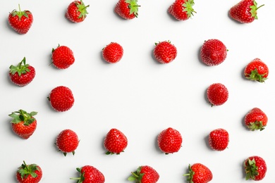 Flat lay composition with with tasty ripe strawberries on light background