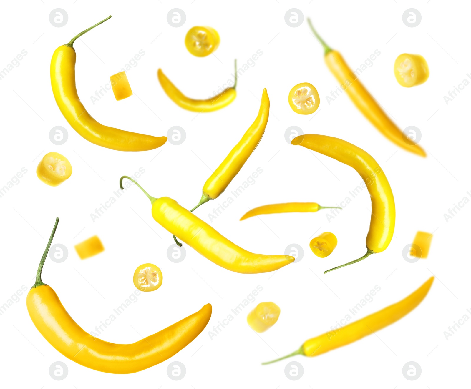 Image of Ripe yellow chili peppers falling on white background 