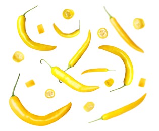 Image of Ripe yellow chili peppers falling on white background 