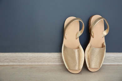 Pair of female shoes on floor near wall