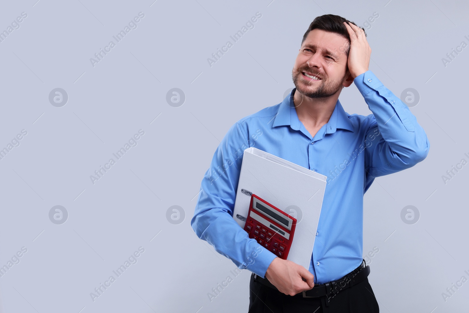 Photo of Confused accountant with calculator and folder on light grey background. Space for text