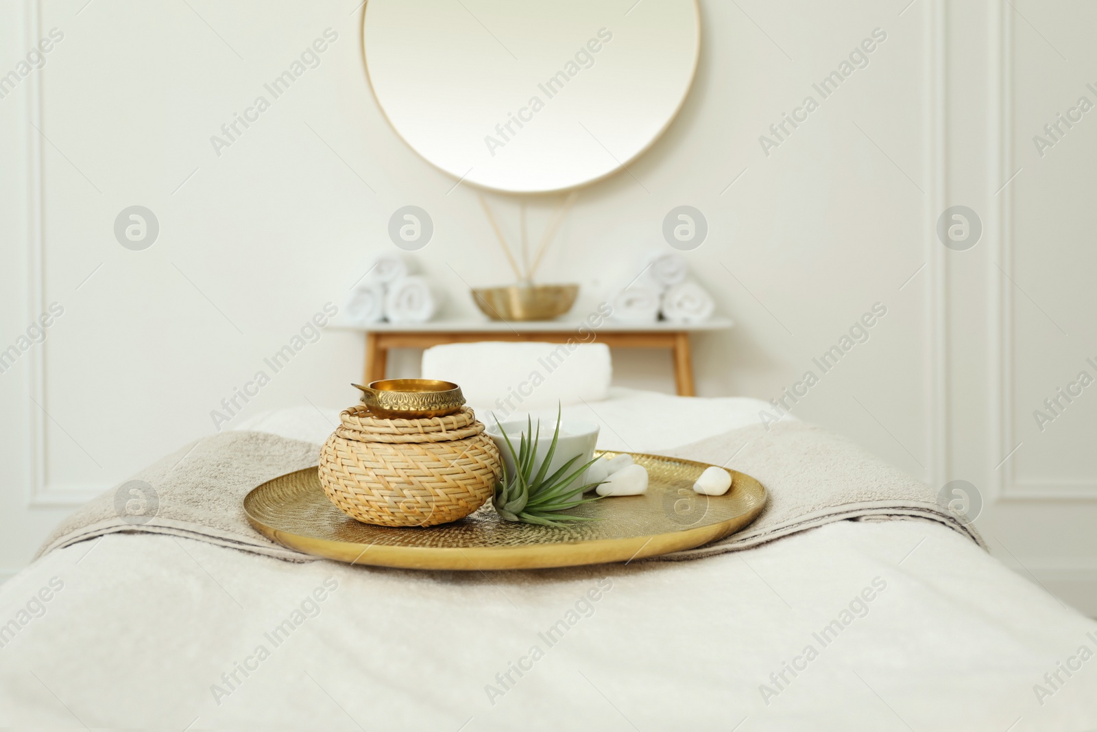 Photo of Beautiful spa composition on massage table in wellness center