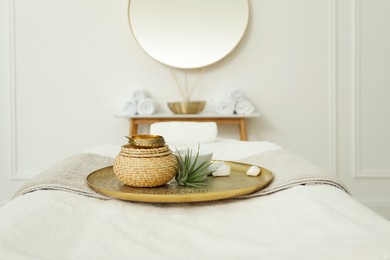 Photo of Beautiful spa composition on massage table in wellness center