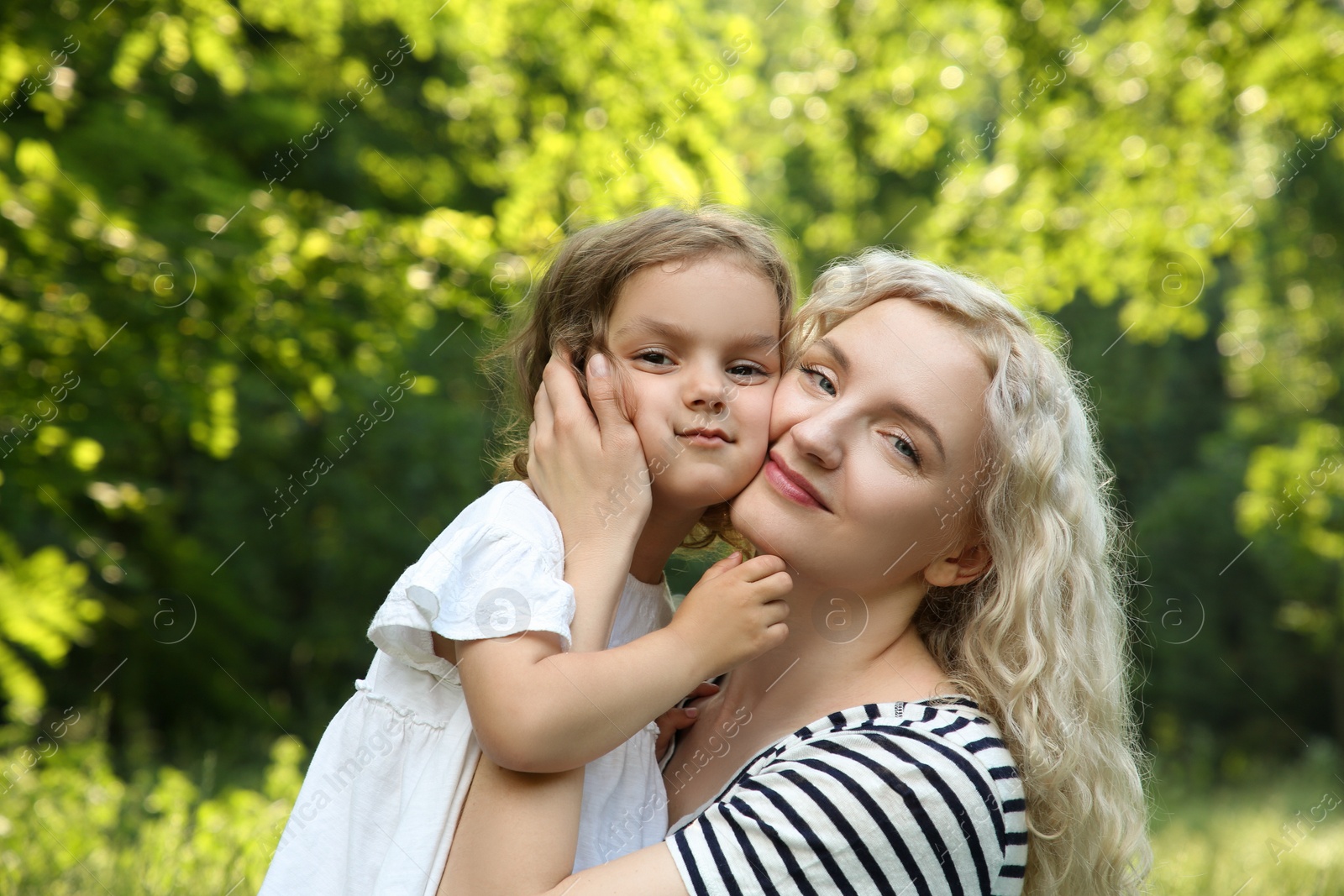 Photo of Portrait of beautiful mother with her cute daughter outdoors